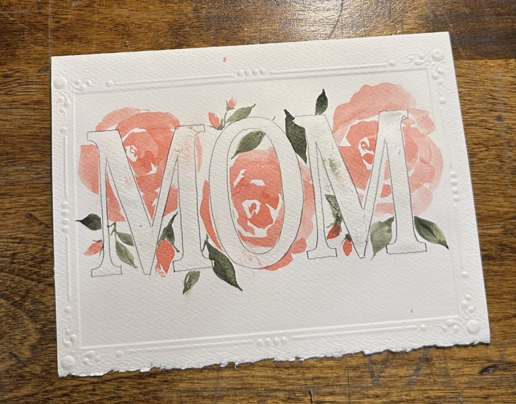 Flowers behind the letters M-O-M